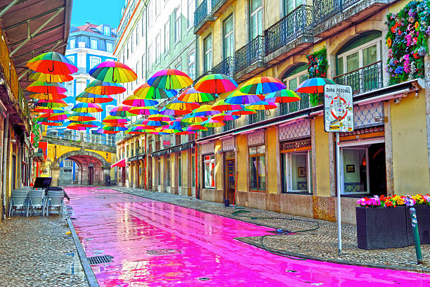 Pink Street (Rua Nova do Carvalho) This street is famous for its pink-painted pavement and the colorful umbrellas suspended above the heads of passer 30 May 2025 Lisbon Portugal