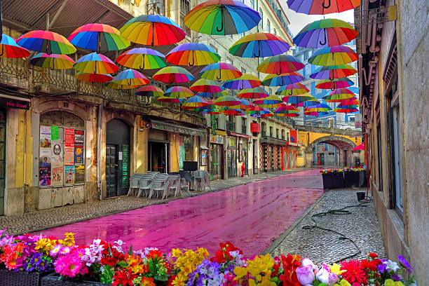 Pink Street (Rua Nova do Carvalho) This street is famous for its pink-painted pavement and the colorful umbrellas suspended above the heads of passer 30 May 2025 Lisbon Portugal