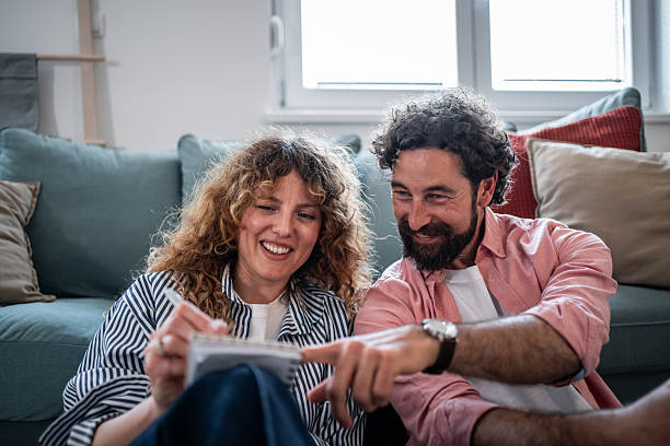 istock Couple planning future and writing notes at home 2240992905