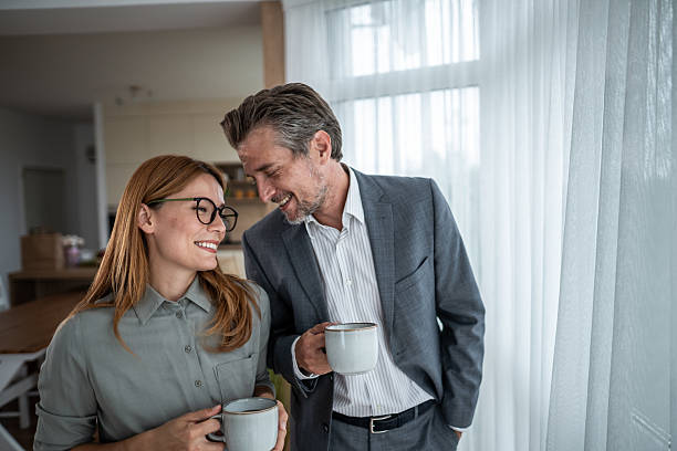 istock Business couple sharing coffee break, smiling and having affection 2240994925