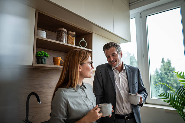 istock Business colleagues having coffee break in office kitchen 2240995468