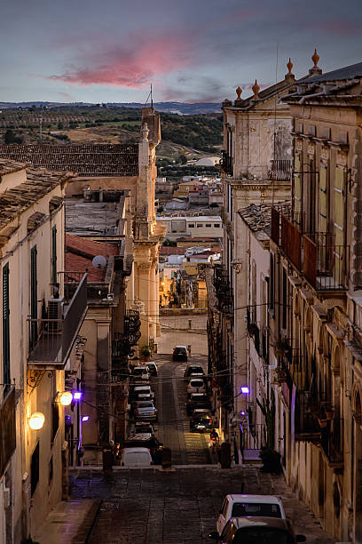 Beautiful evening view of the old town of Noto in Sicily, Italy. Historic baroque architecture, narrow streets and sunset sky creating a warm Mediterranean atmosphere.