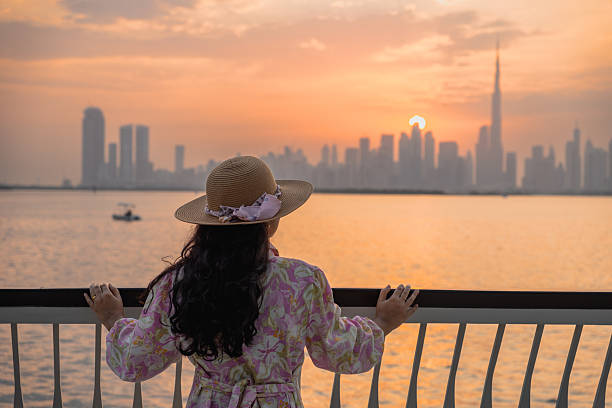 istock Dubai skyline with Burj Khlaifa at sunset, creek waterfront foreground with sunset reflection in water 2240998328