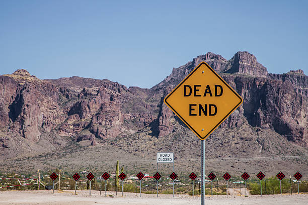 endo of rural road in the desert with mountains