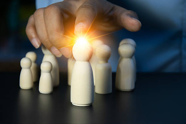 istock Wooden figures representing leadership and team 2241001090
