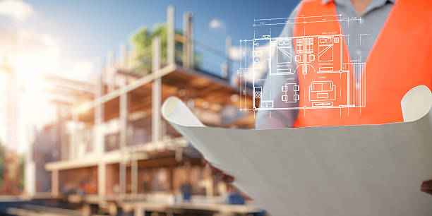 Engineer holding construction blueprint template for building, house, checking accuracy.