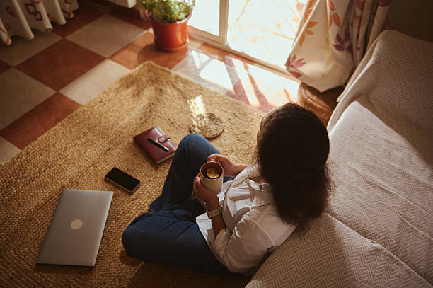 istock Cozy Home Office Moment With Laptop, Coffee, And Warm Sunlit Window 2241001978