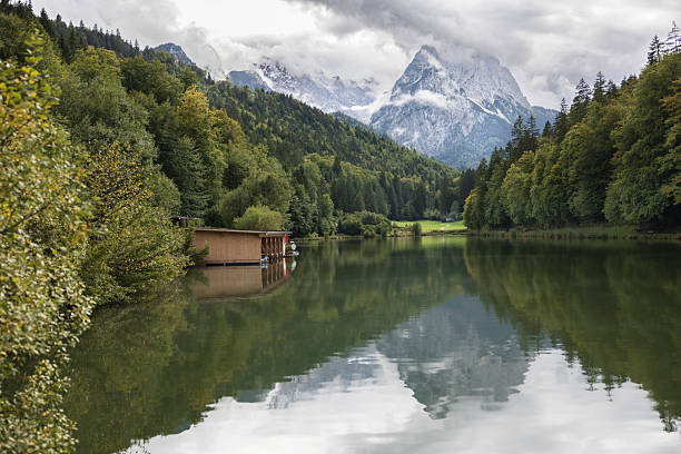 alpine lake with mountains and moody clouds