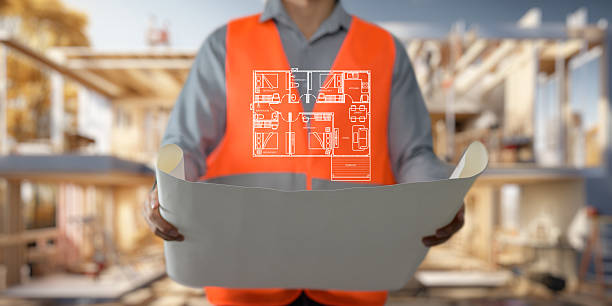 istock Engineer holding construction blueprint template for building, house, checking accuracy. 2241003774