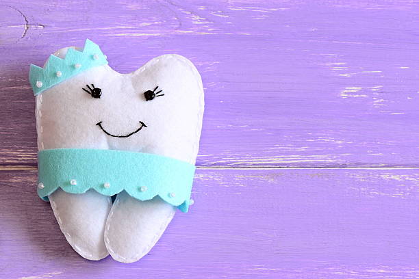 istock Felt tooth fairy pillow isolated on wooden background with copy space for text. Top view. Closeup 2241009502