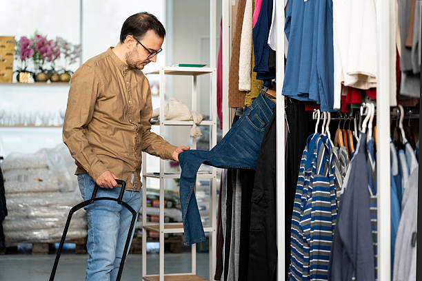 istock Man shopping for jeans in a retail store 2241010951