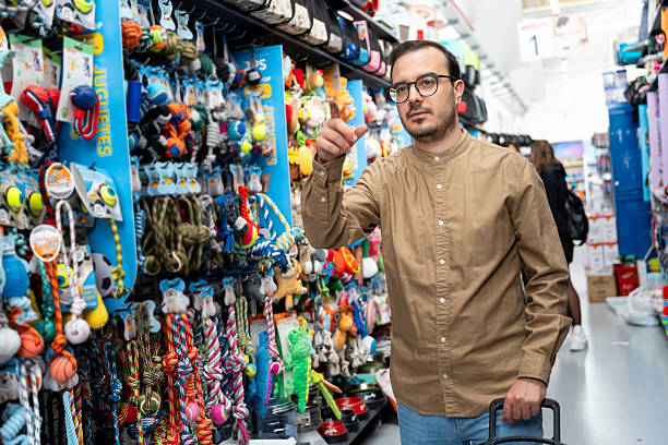 istock Man choosing pet toys in store aisle 2241010986