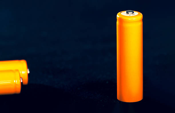 istock Three Orange AA batteries. Electricity charging. Battery for toys, electronics and equipment. Backup power supply. 2241014877