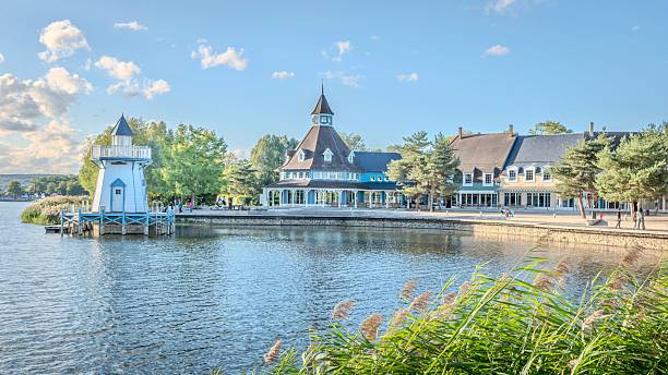 istock Charming lakeside village with lighthouse. 2241014933