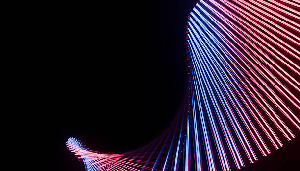 istock Futuristic abstract light installation with vibrant red and blue neon lines creating dynamic spiral pattern against dark background 2241015196