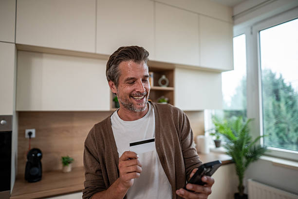 istock Man using credit card and phone for online shopping 2241015197