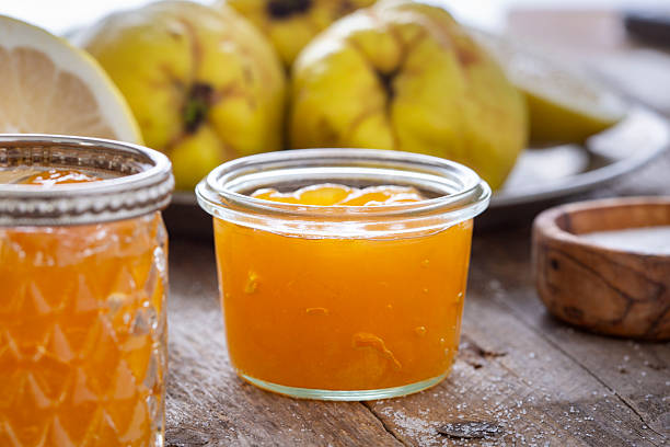Quince, lemon and fresh jam on wooden table