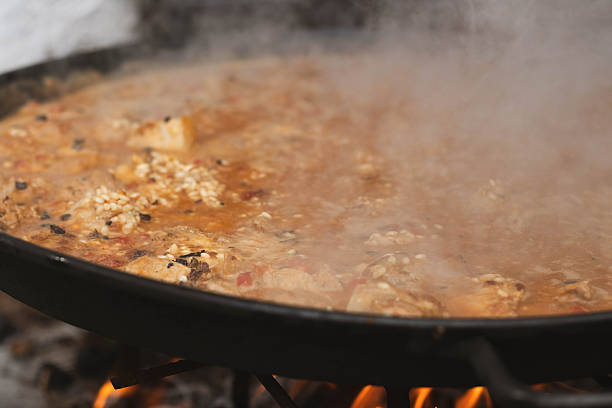 istock Traditional Spanish rice dish cooking on fire 2241018764