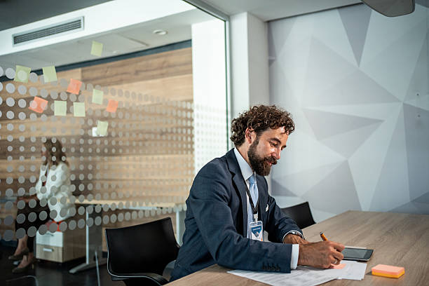 istock Businessman writing notes during an important office meeting 2241024586