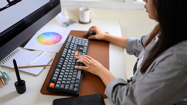 istock Graphic designer working on computer with color palette and digital tablet in modern workspace 2241024619
