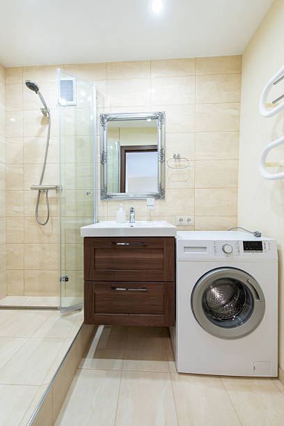 istock Modern Bathroom Interior with Shower, Sink, and a Washing Machine 2241025907