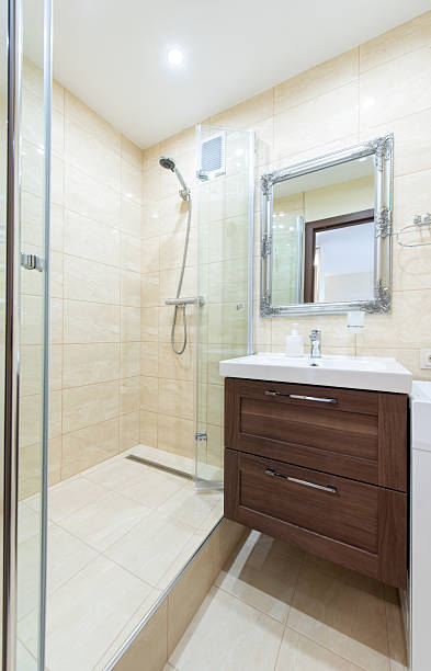 istock Modern Bathroom Interior with Shower, Sink, and a Washing Machine 2241025993
