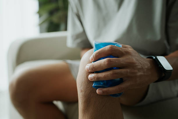 istock Man applying cold gel pack on painful knee. 2241026176