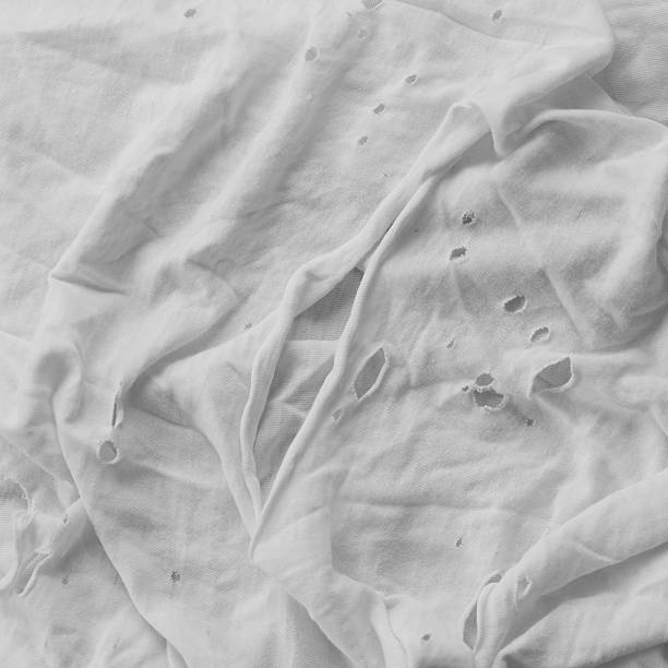 istock A worn t-shirt with holes. Black and white. 2241027559
