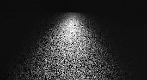 istock Abstract background photo texture of a textured wall lit by a single overhead light 2241027813