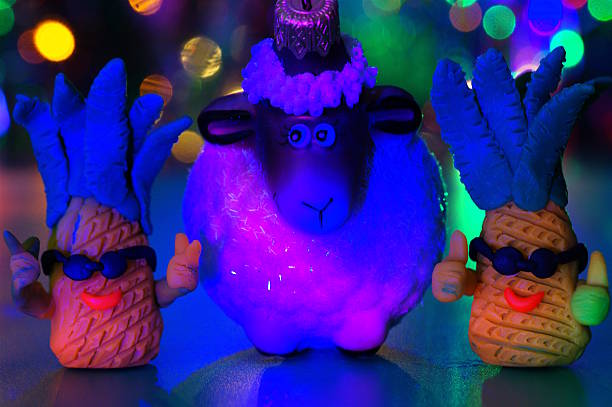 Plasticine toy pineapples and a toy sheep. Festive decorations.