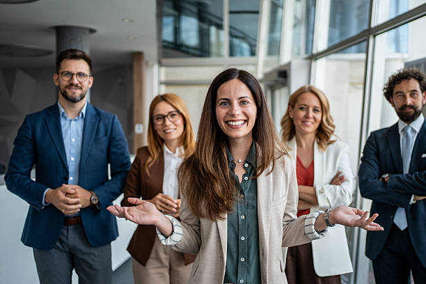 istock Business team smiling, welcoming clients in modern office 2241029642