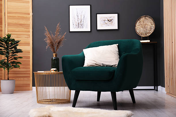 istock Contemporary armchair with pillow, rug and side table indoors. Interior design 2241032527