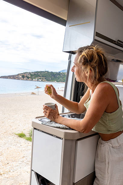 istock Morning Routine: Woman Preparing Lemon Drink Inside Camper Van 2241033064
