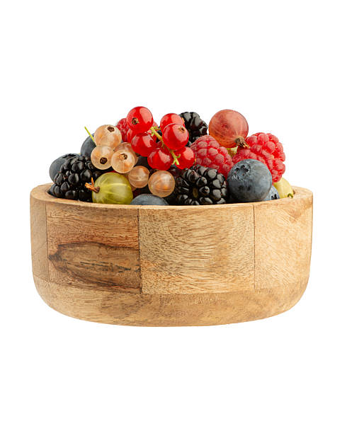 istock Different berries in a wooden plate on a white isolated background 2241038033