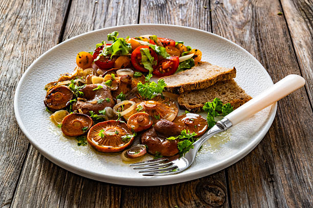 istock Fried saffron milk cap mushrooms on wooden table 2241038404