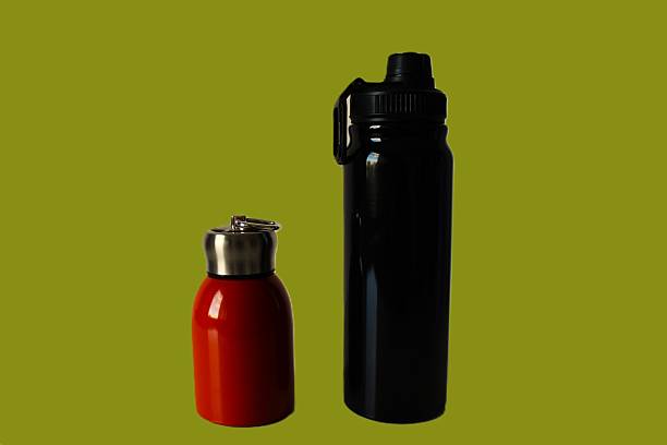 istock composition with a large and a small thermos. Horizontal photo with pistachio green background 2241040908