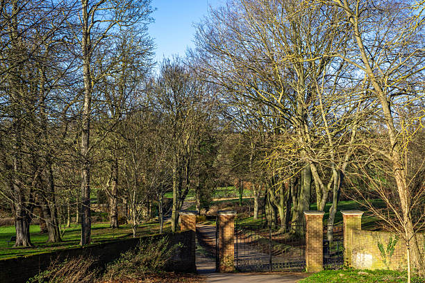 Saffron Walden, Essex, UK - January 15, 2024: The entrance gates to Bridge End Gardens, Saffron Walden, Essex, England, in winter with bare trees