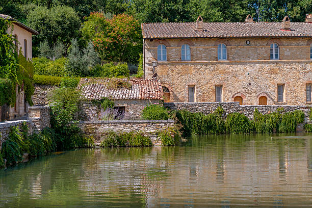 istock Stone Bathhouse with Vegetation beside Thermal Pool 2241043625