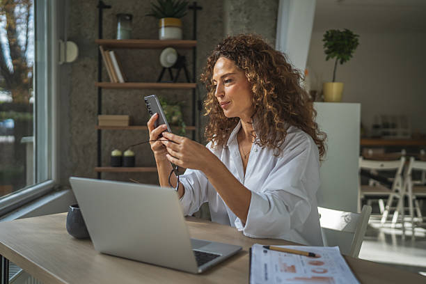 istock Woman working and communicating on phone from home office 2241047116