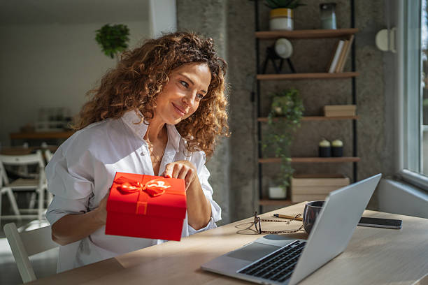 istock Woman celebrating receiving virtual gift during video call 2241047258