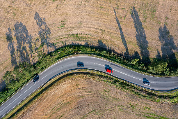 istock Winding road with cars from above 2241047511