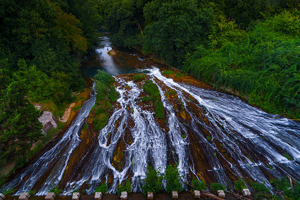 istock Wide forest waterfall, rapid streams and lush green nature 2241049825