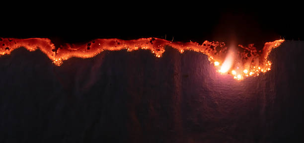 istock burning paper, glowing edge of paper on a black background 2241051762
