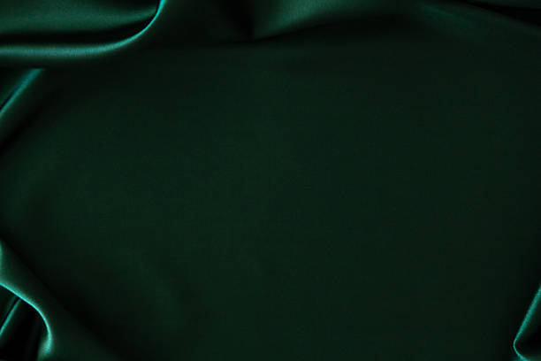 istock Beautiful elegant emerald green silk fabric background. Softly draped silk with natural ripples on sides. Top view, copy space 2241052557