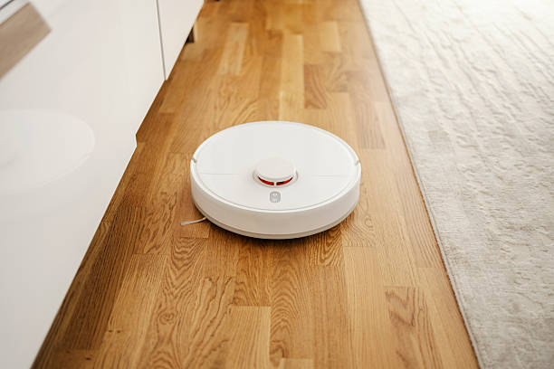 istock Robot vacuum cleaning a modern wooden floor 2241057528