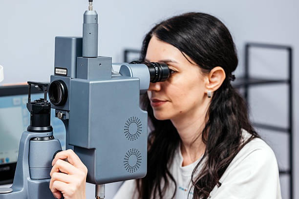 istock Female ophthalmologist using a slit lamp for a detailed vision examinatio 2241061751