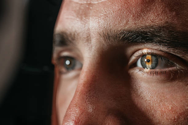 istock Male patient undergoing detailed vision examination using a slit lamp device 2241061923