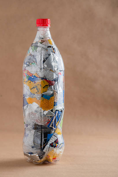 istock Plastic ecobrick bottle filled with compacted waste against neutral background 2241063422
