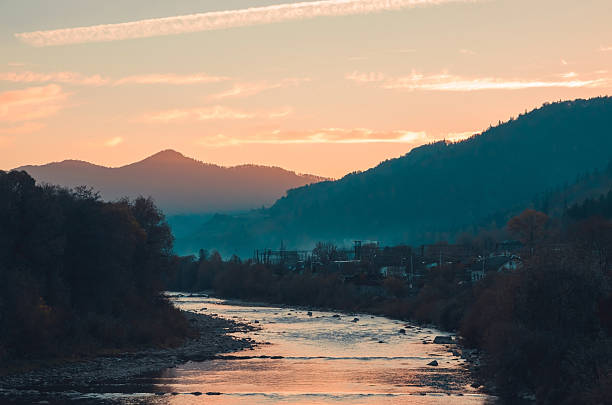 Mountain river at sunset with fog. Beautiful evening in mountains