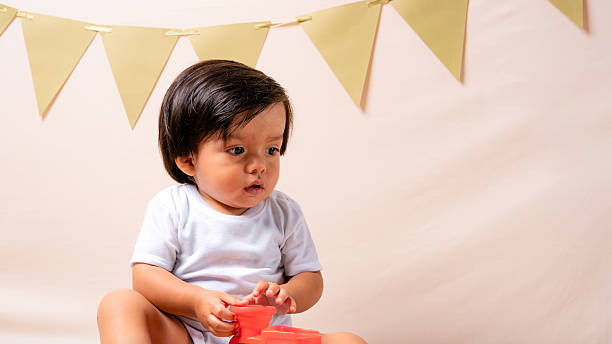istock Baby boy playing with toy during celebration party 2241067187